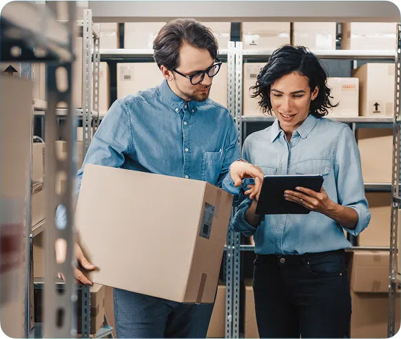 Two people in a warehouse with boxes