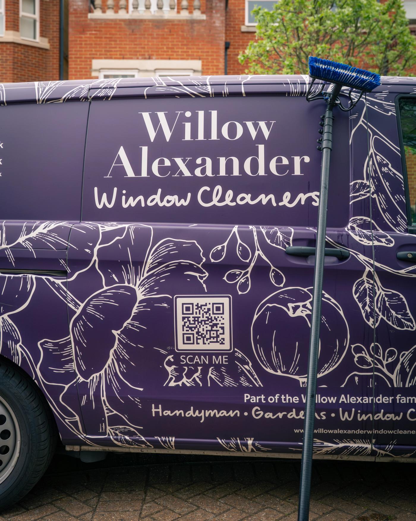 A fully electric cleaning vehicle parked outside a well-kept Kent home, with clean upper windows, clipped hedging and a discreet professional setup