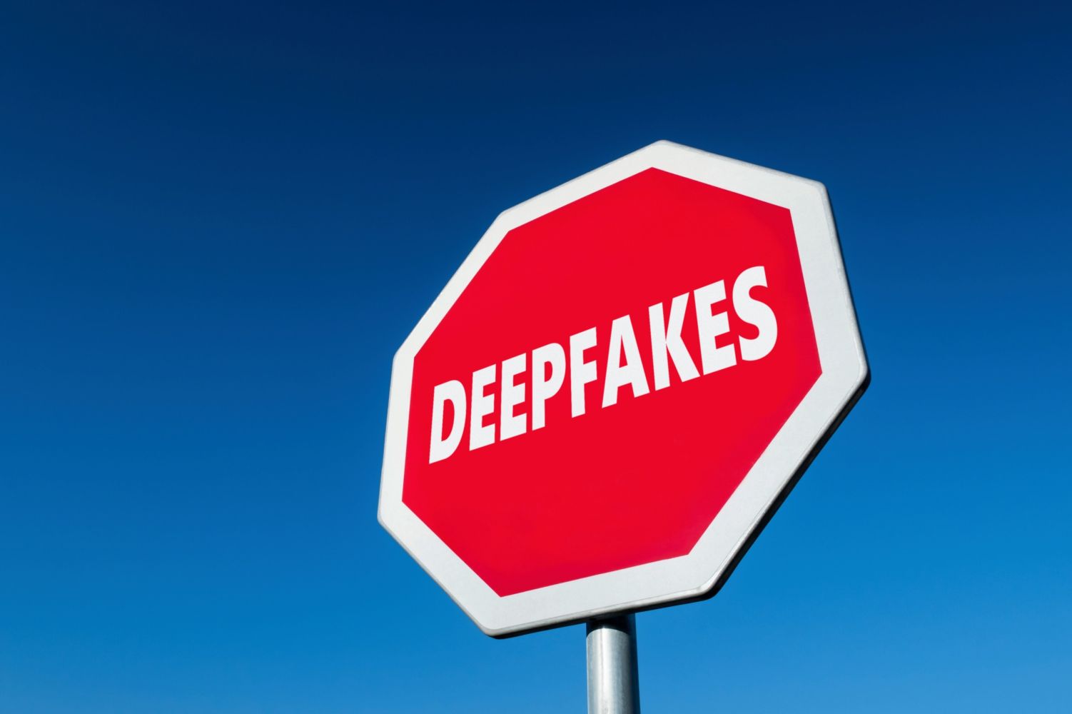 stop sign with text on it that says deepfakes