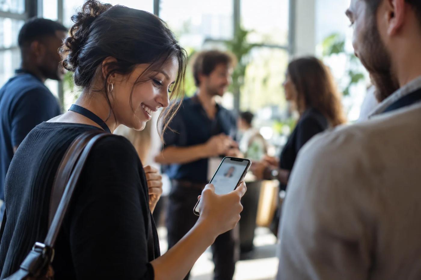A professional using a phone at an illustrative community event.
