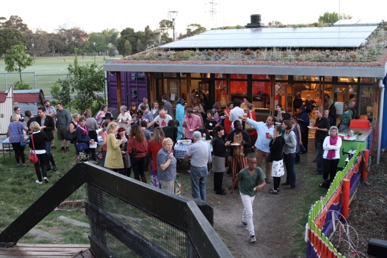 A large group of people gather outside a building for an event as part of Chamber Made's The Venny Project 2012-2014