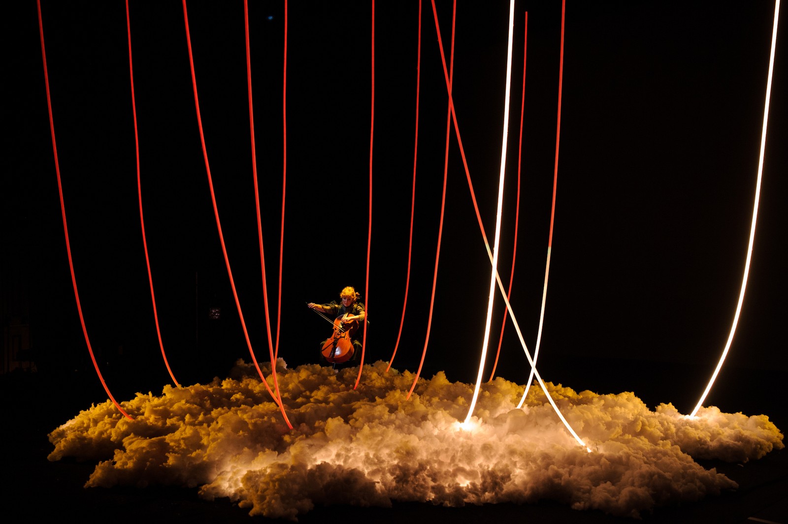 In a darkened space a woman plays a cello as part of The Nervous Atmosphere by Zoe Barry and Chamber Made