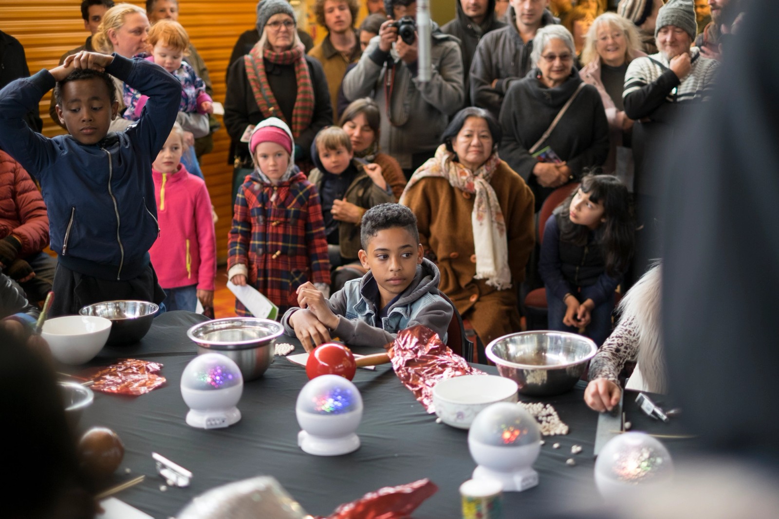 A large group of people gather to watch a performance as part of Chamber Made's The Venny Imagine a Place 2017