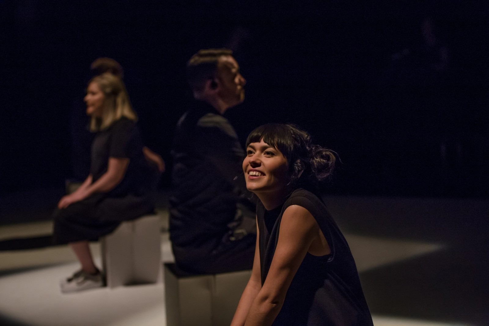 Four performers lined up sitting on white boxes as part of Permission to Speak by Chamber Made