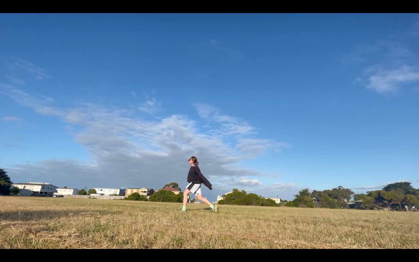 A woman dancing in a field from Orange House Resident Rebecca Jensen