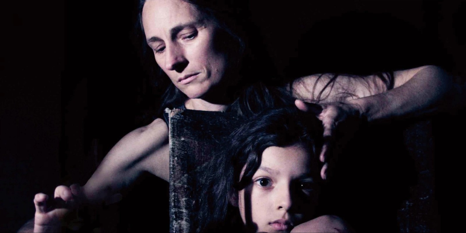 A woman stands behind a child as part of Exile by Chamber Made