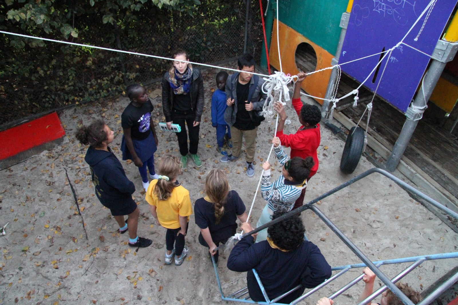 A group of people in a circle play a game as part of Chamber Made's The Venny Project 2012-2014