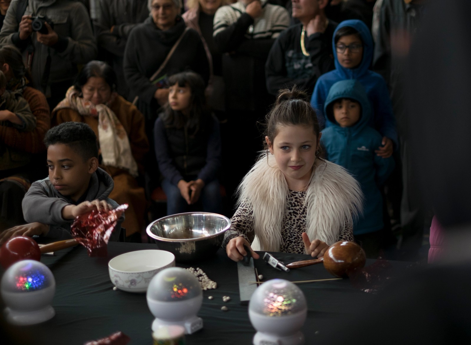 Two children perform with unusual percussive objects while an audience watches as part of Chamber Made's The Venny Imagine a Place 2017