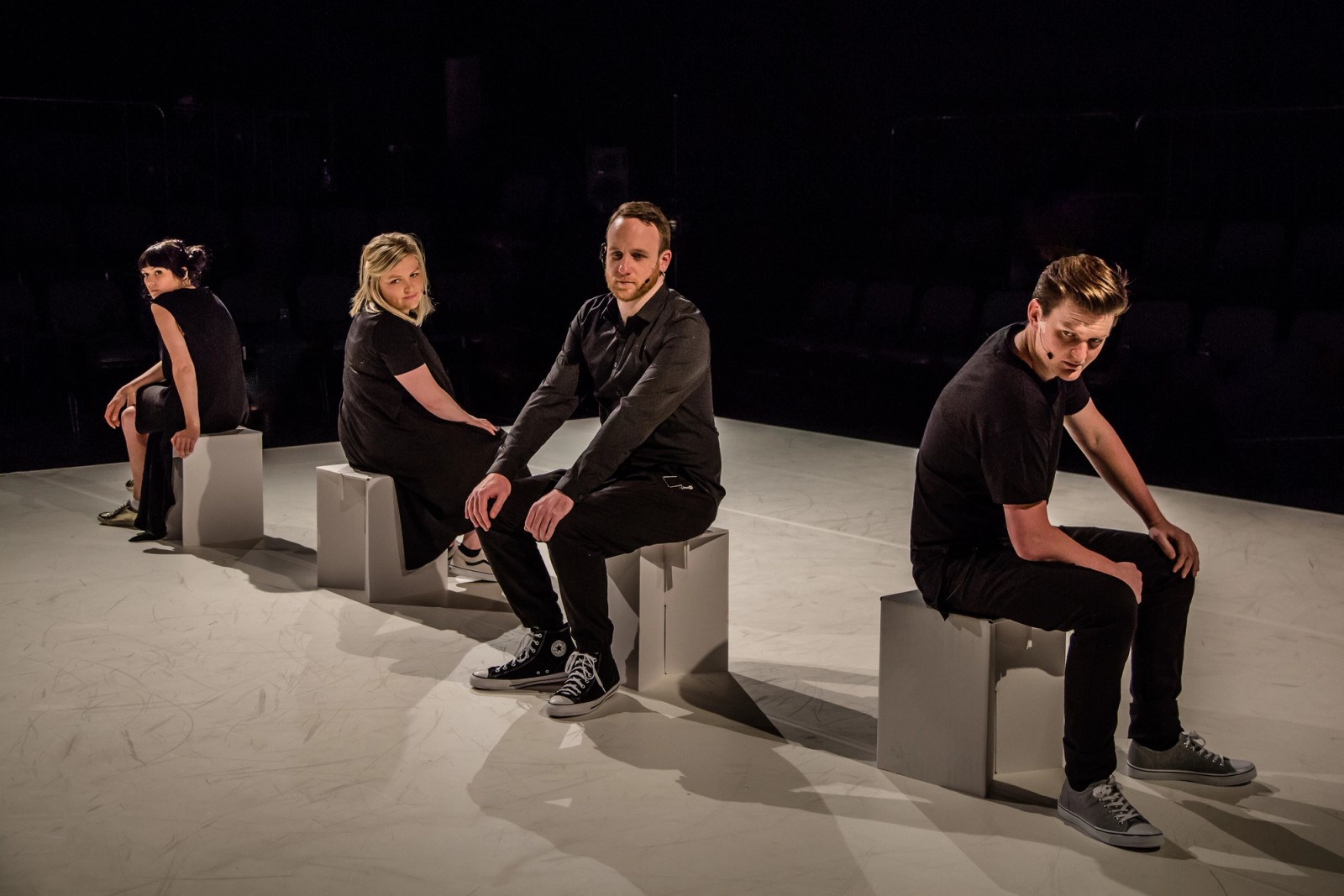 Four performers sit on white boxes as part of Permission to Speak by Chamber Made