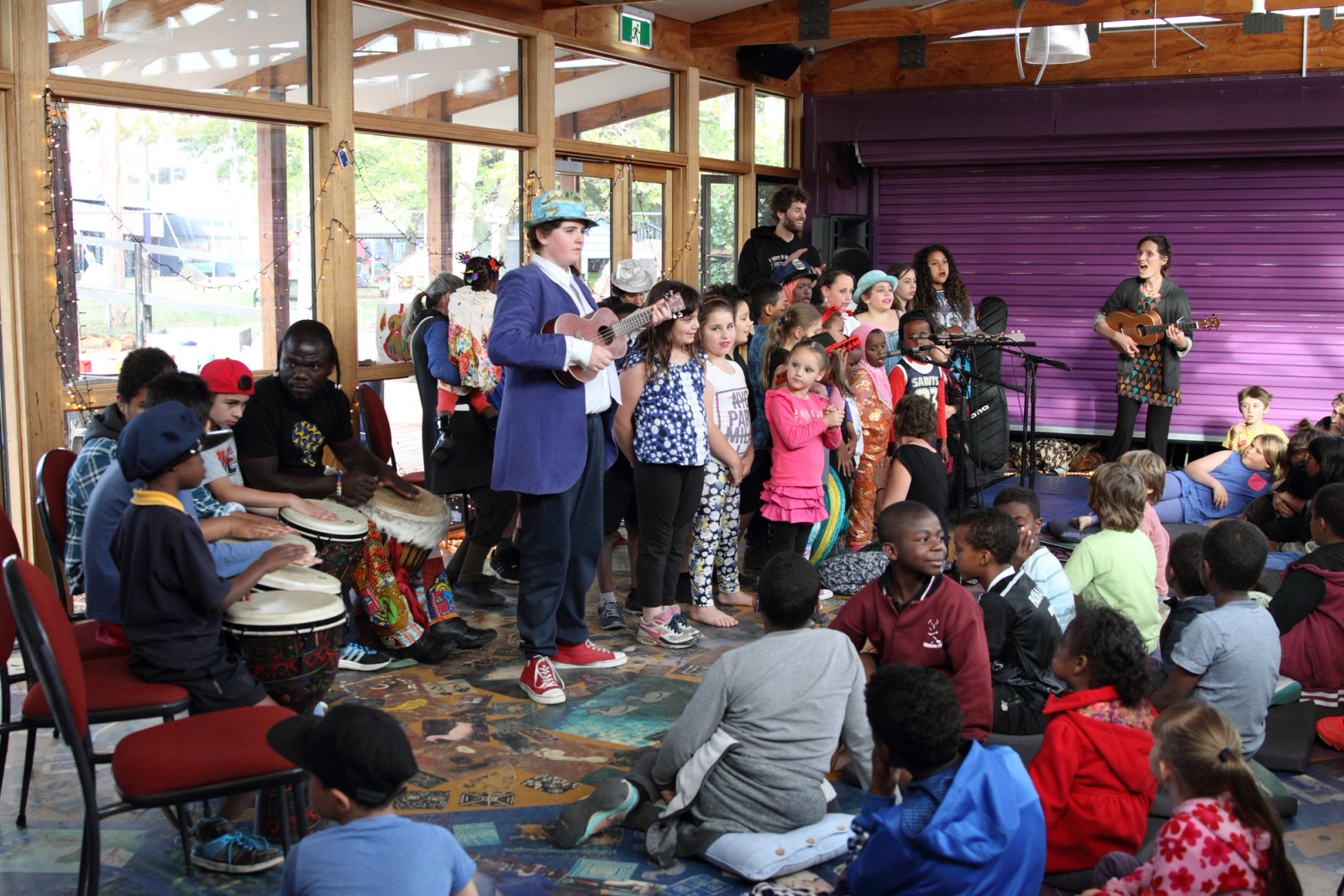 A large group of children perform while others watch on as part of Chamber Made's A Concert at The Venny 2015