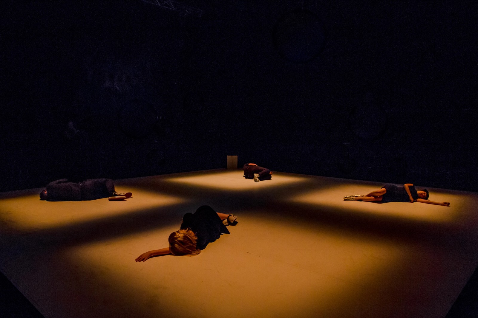 Four performers lie on the floor as part of Permission to Speak by Chamber Made