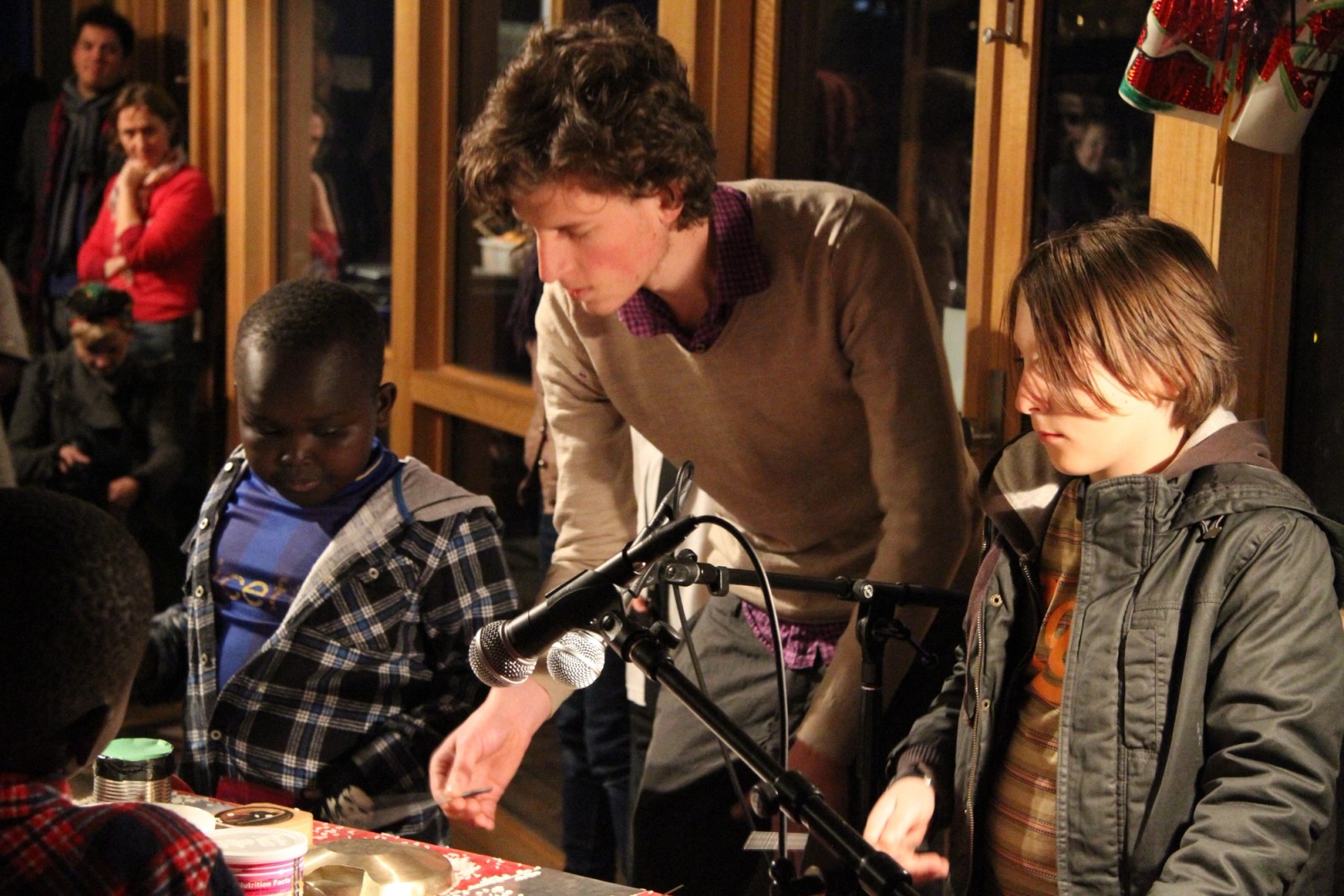 A man instructing childre in an activity while others watch as part of Chamber Made's The Venny Project 2012-2014