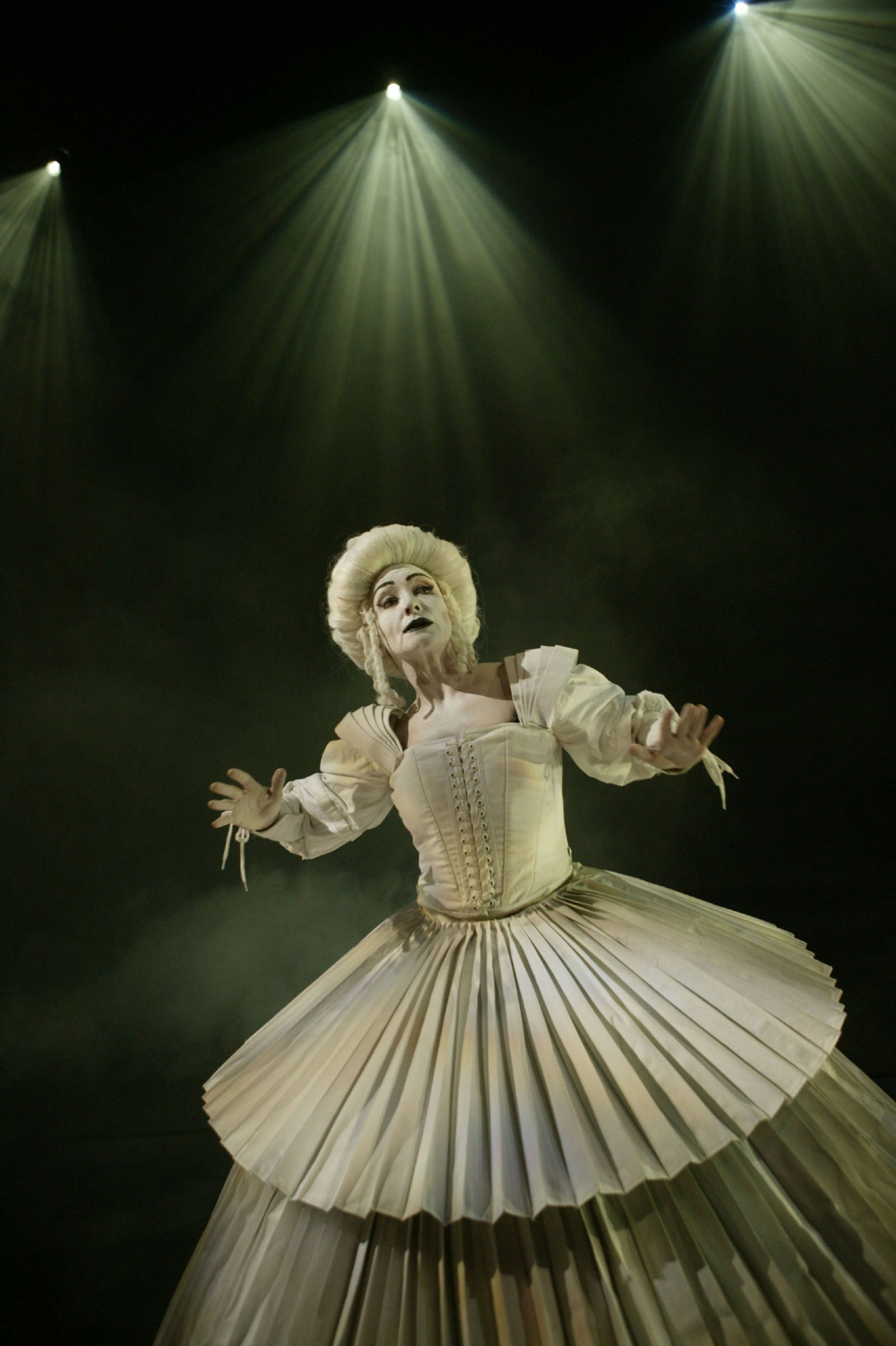 Woman in a white pleated gown with white baroque wig