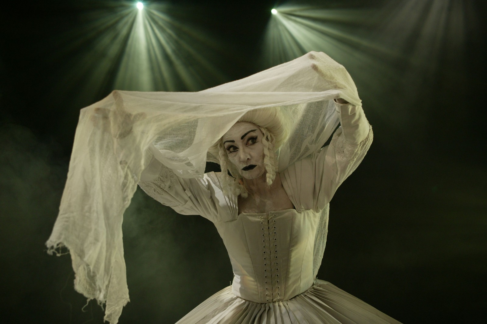 Woman in a white pleated gown with white baroque wig