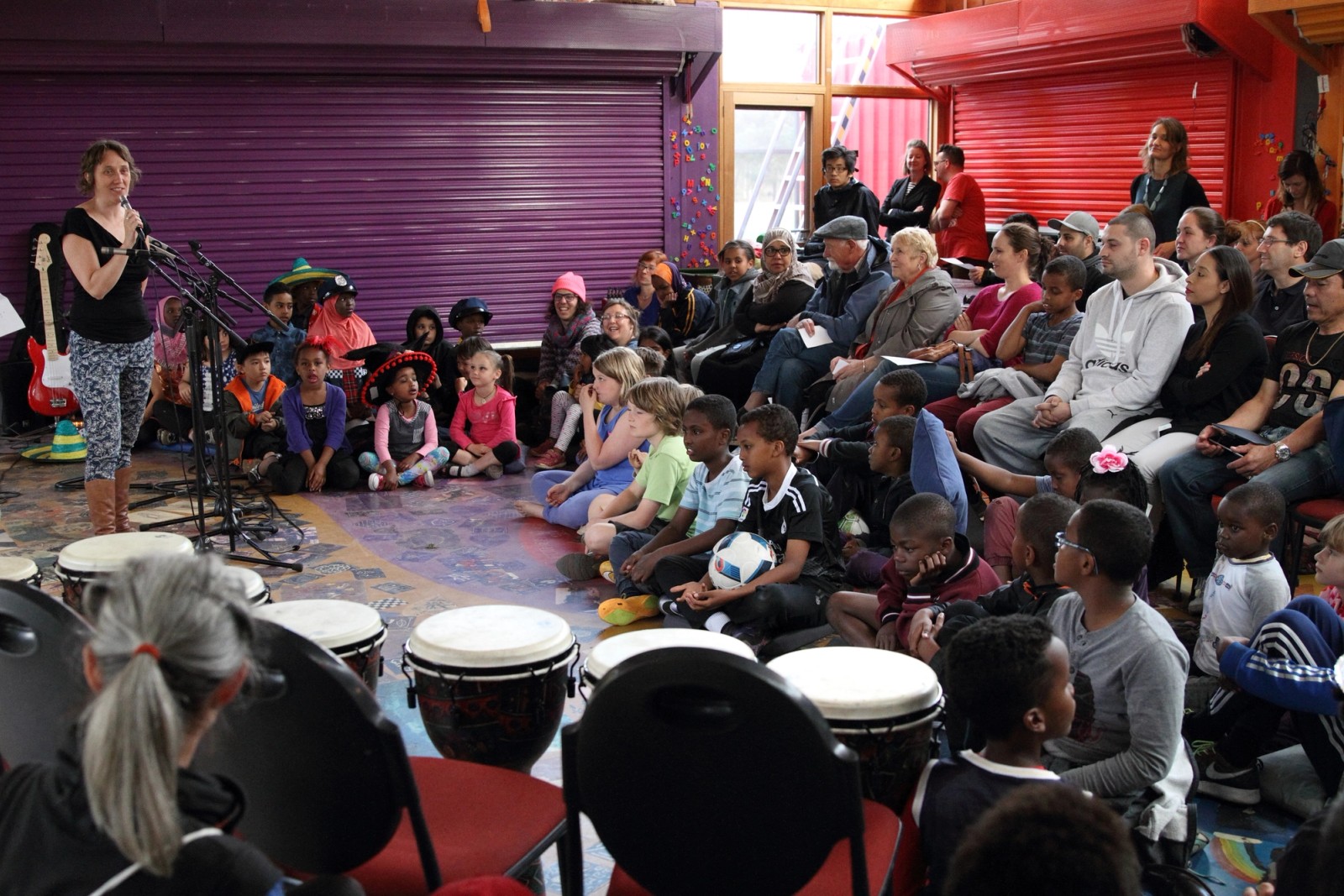 A woman addresses a large audience as part of Chamber Made's A Concert at The Venny 2015