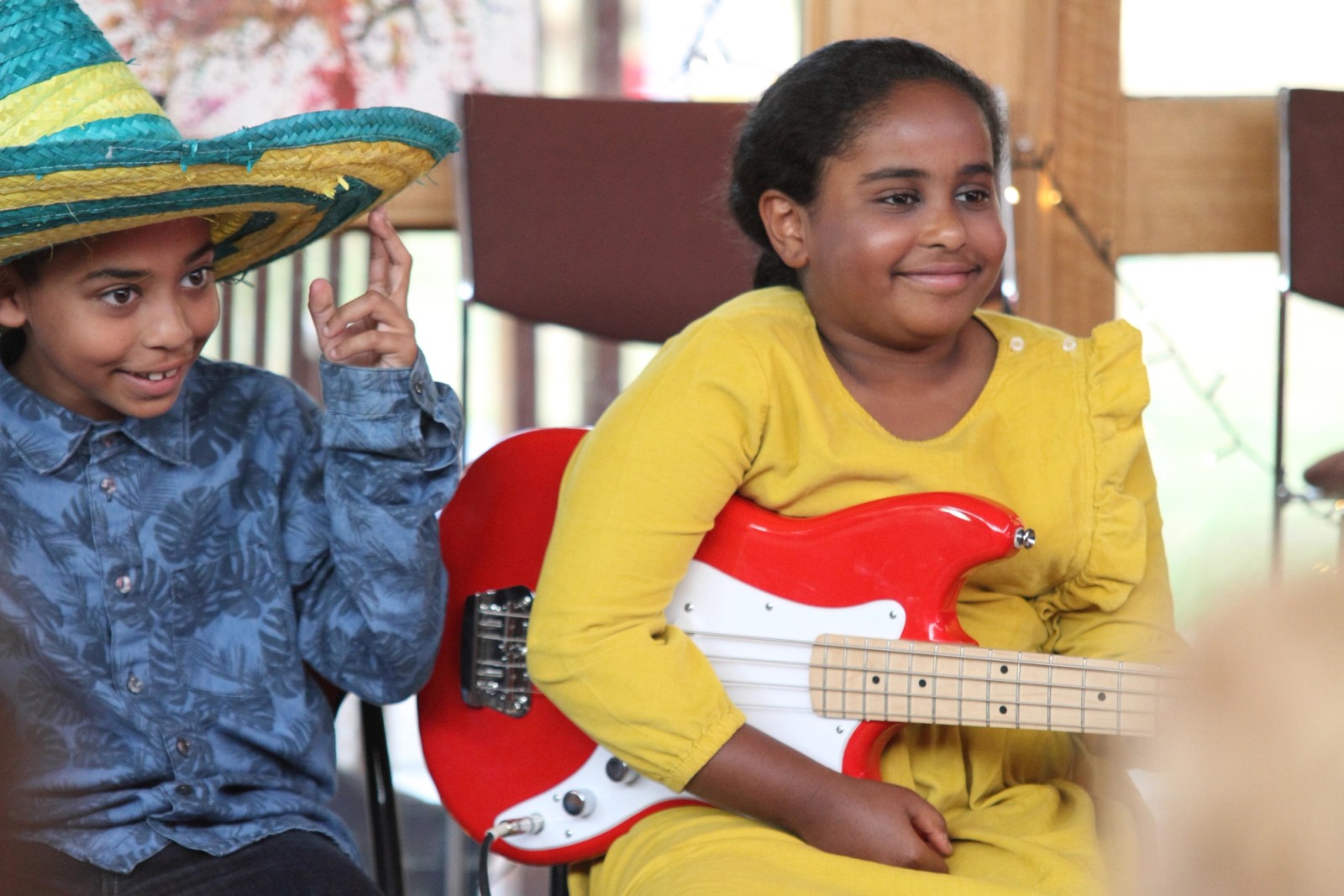 Two smiling children one with a guitar as part of Chamber Made's A Concert at The Venny 2015