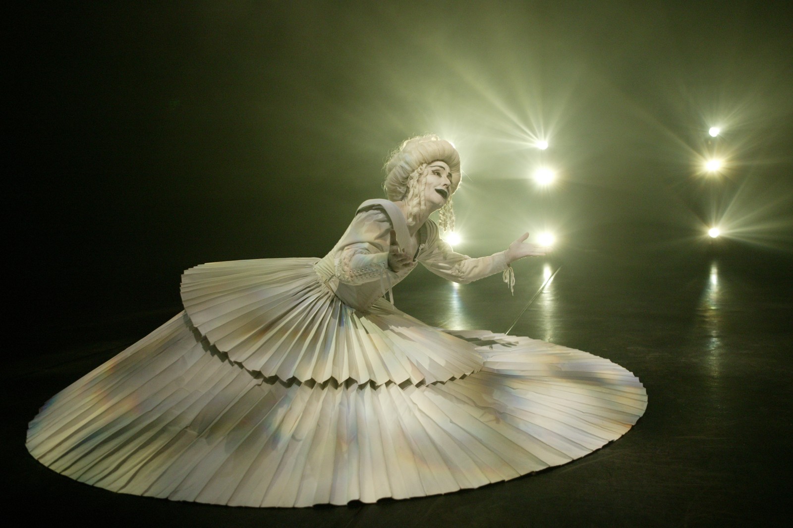 Woman in a white pleated gown with white baroque wig