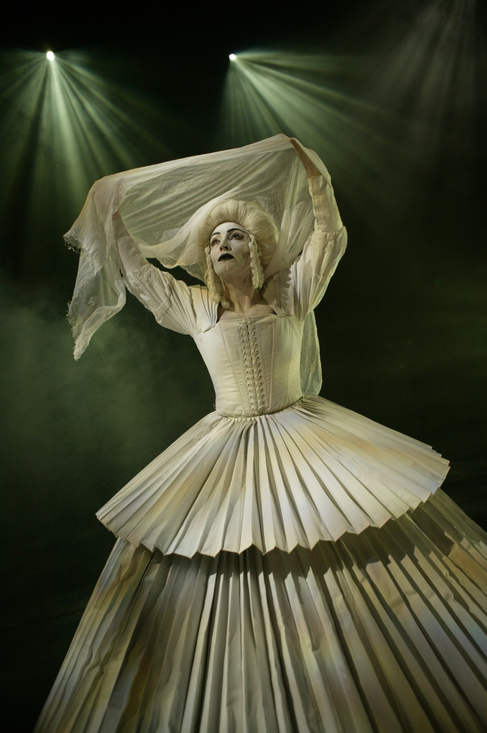 Woman in a white pleated gown with white baroque wig and shawl