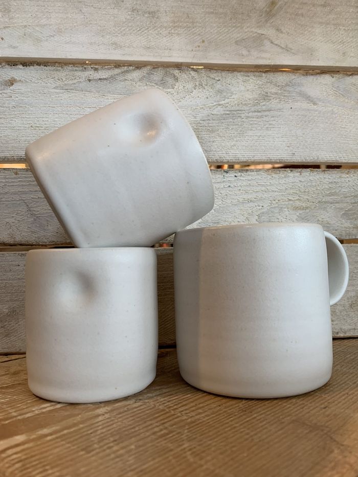 Three matte white stoneware cups and mugs, stacked