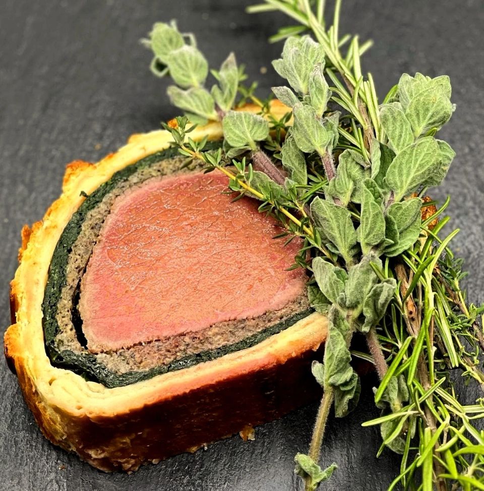 A slice of our beef Wellington with rosemary, thyme and oregano