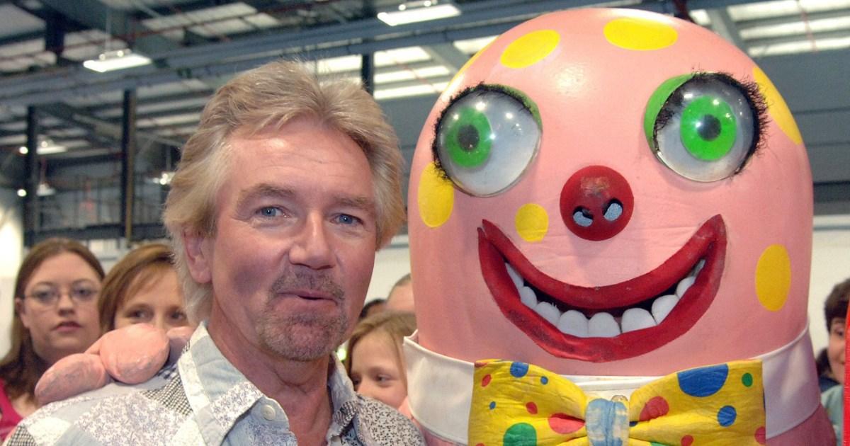 Pictured: a man with a round pink face, standing next to Mr Blobby