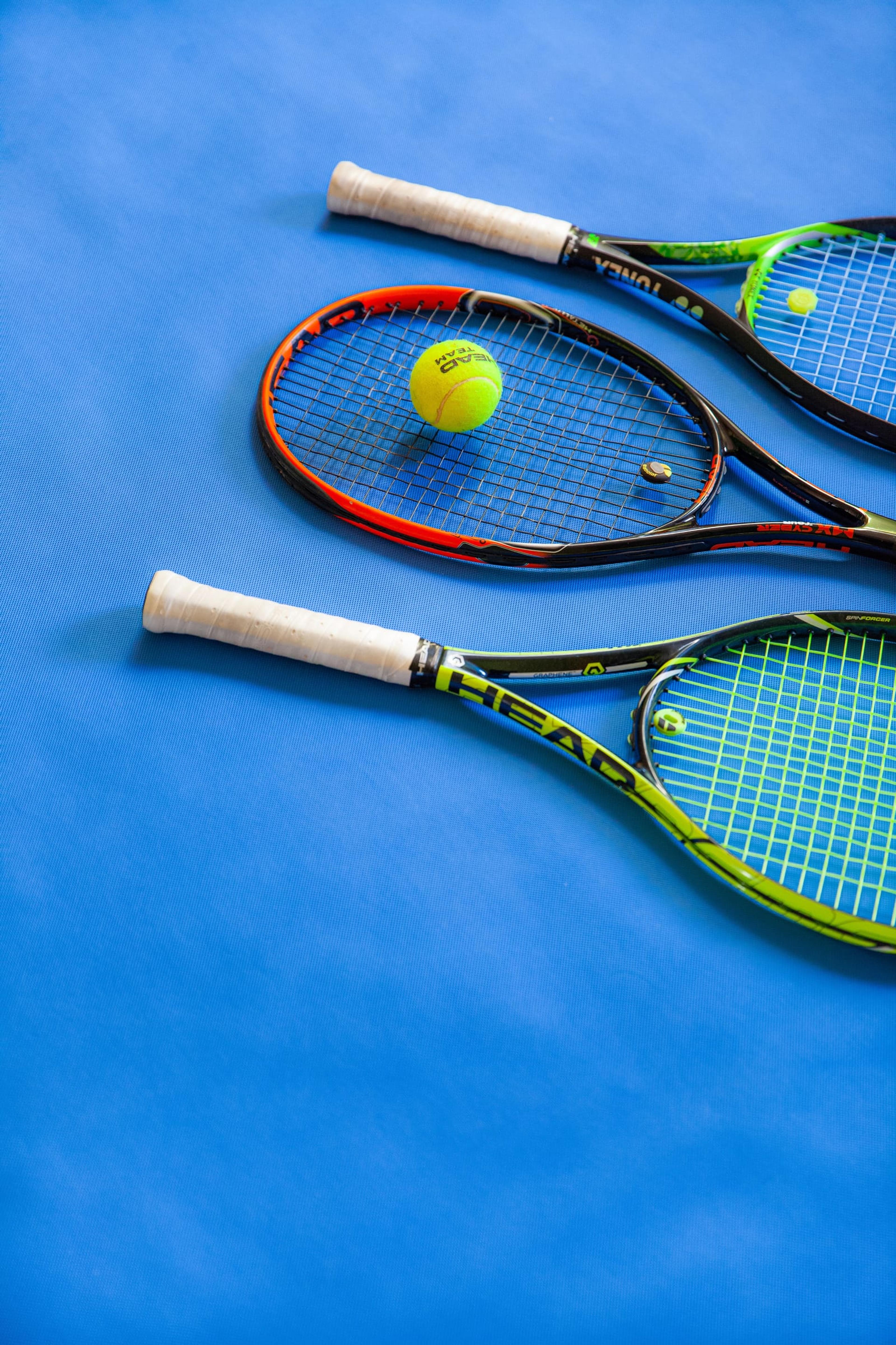 Yellow and black racket on a blue court