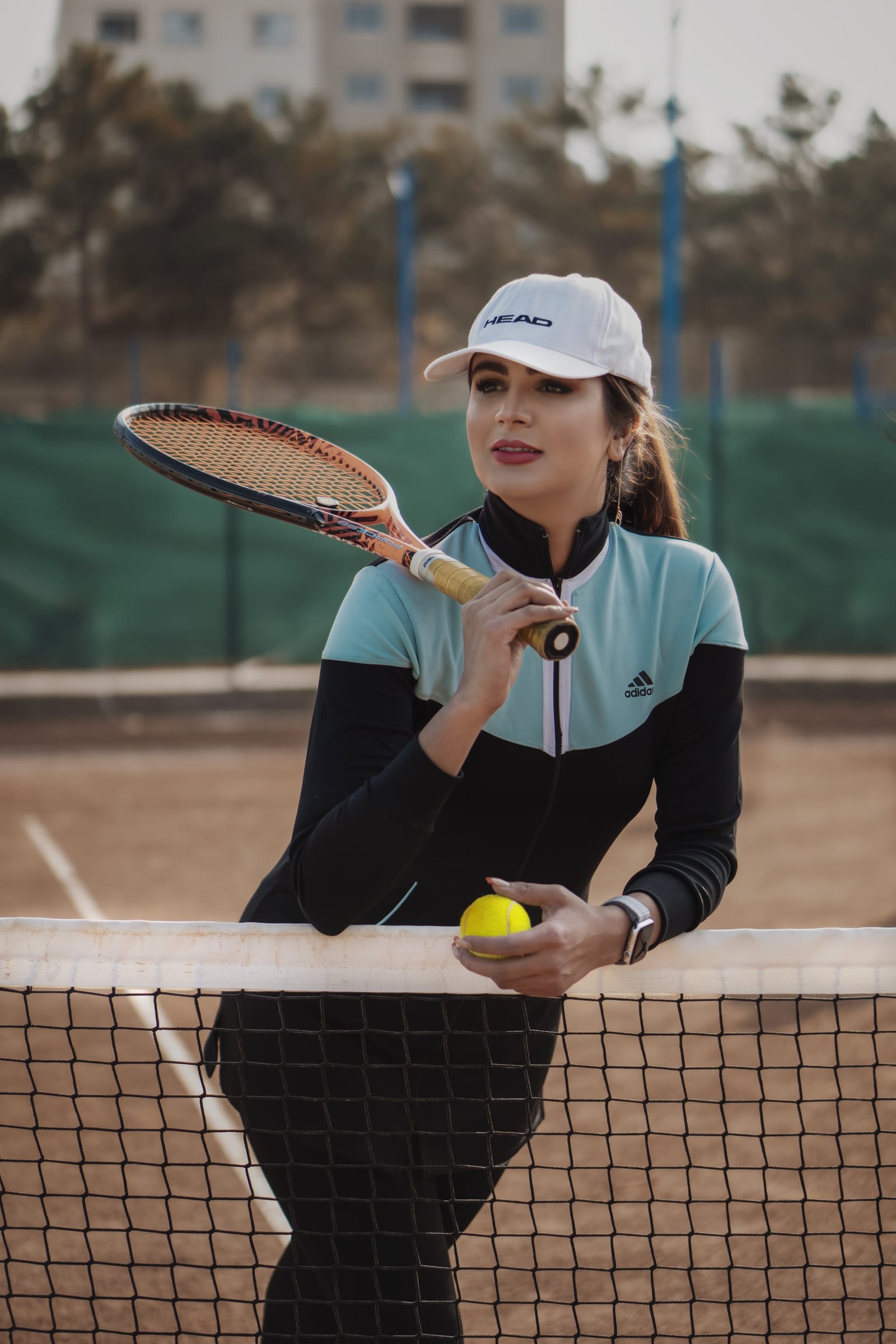 Player in a zip jacket holding a racket