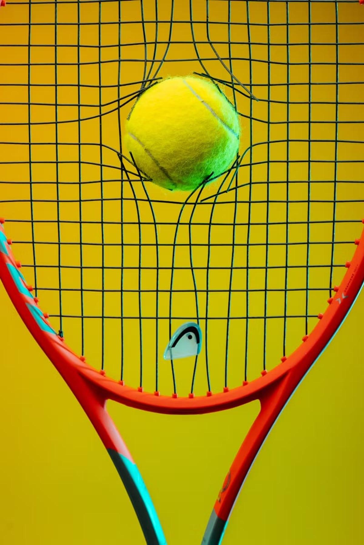 Ball pressed into racket strings