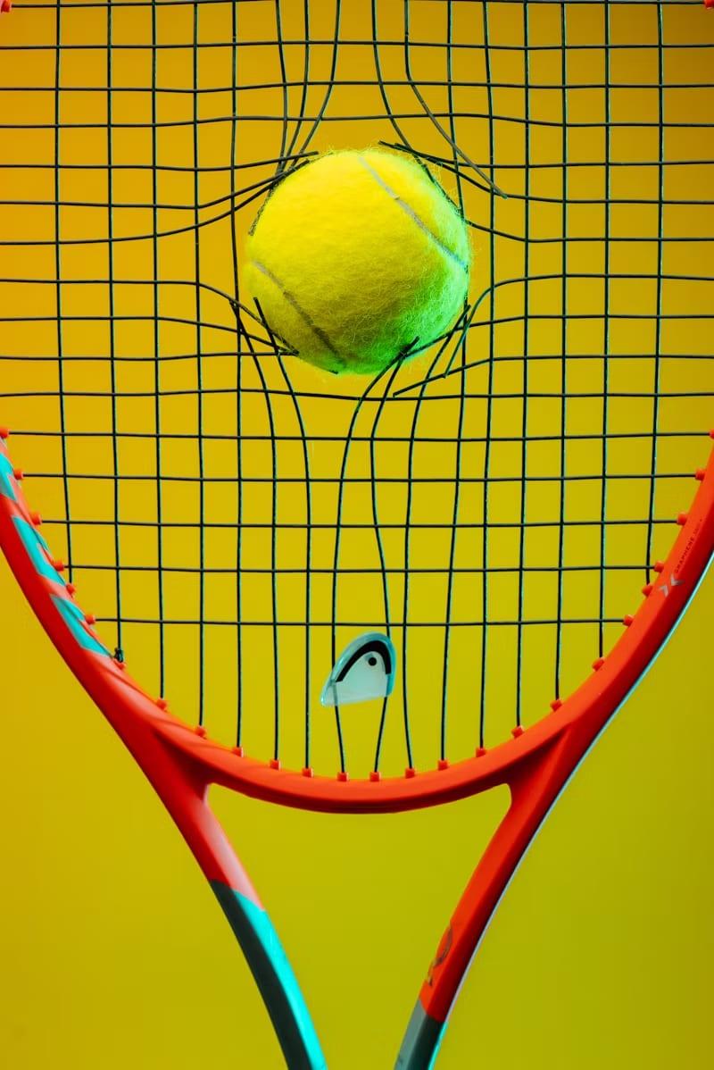 Ball pressed into racket strings