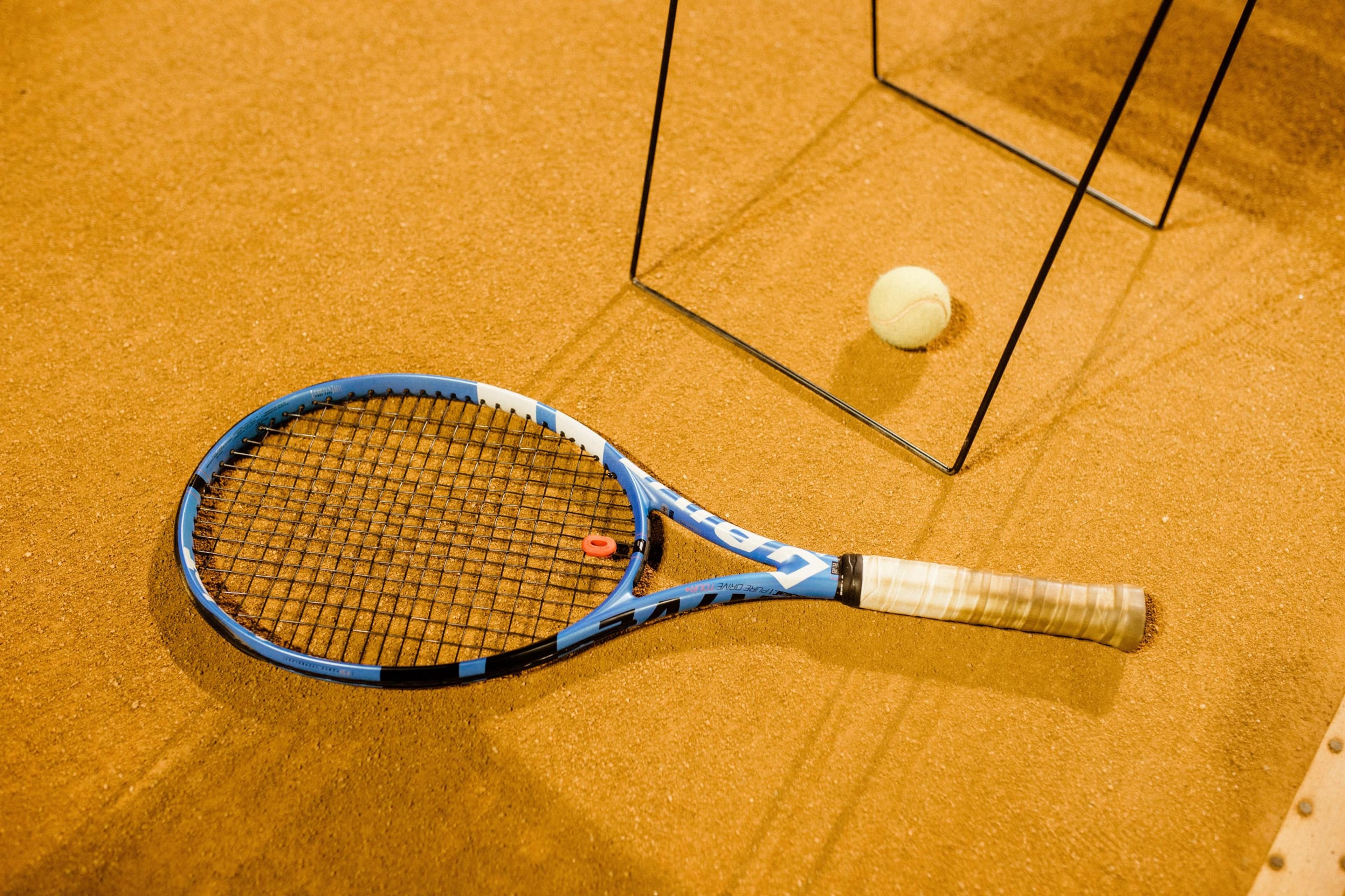Blue and black racket on a clay court