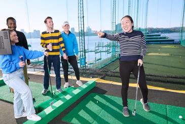 Golfing with friends at the driving range