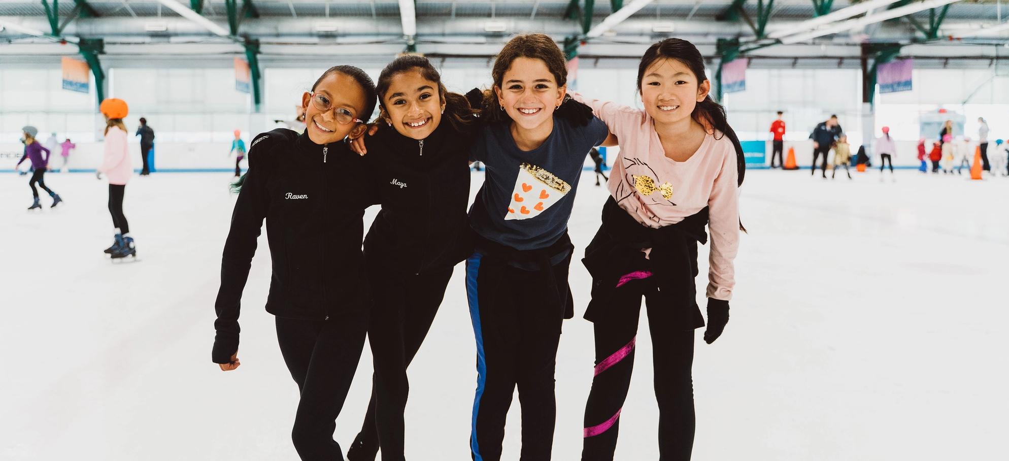 Group of girls smiling on the ice 