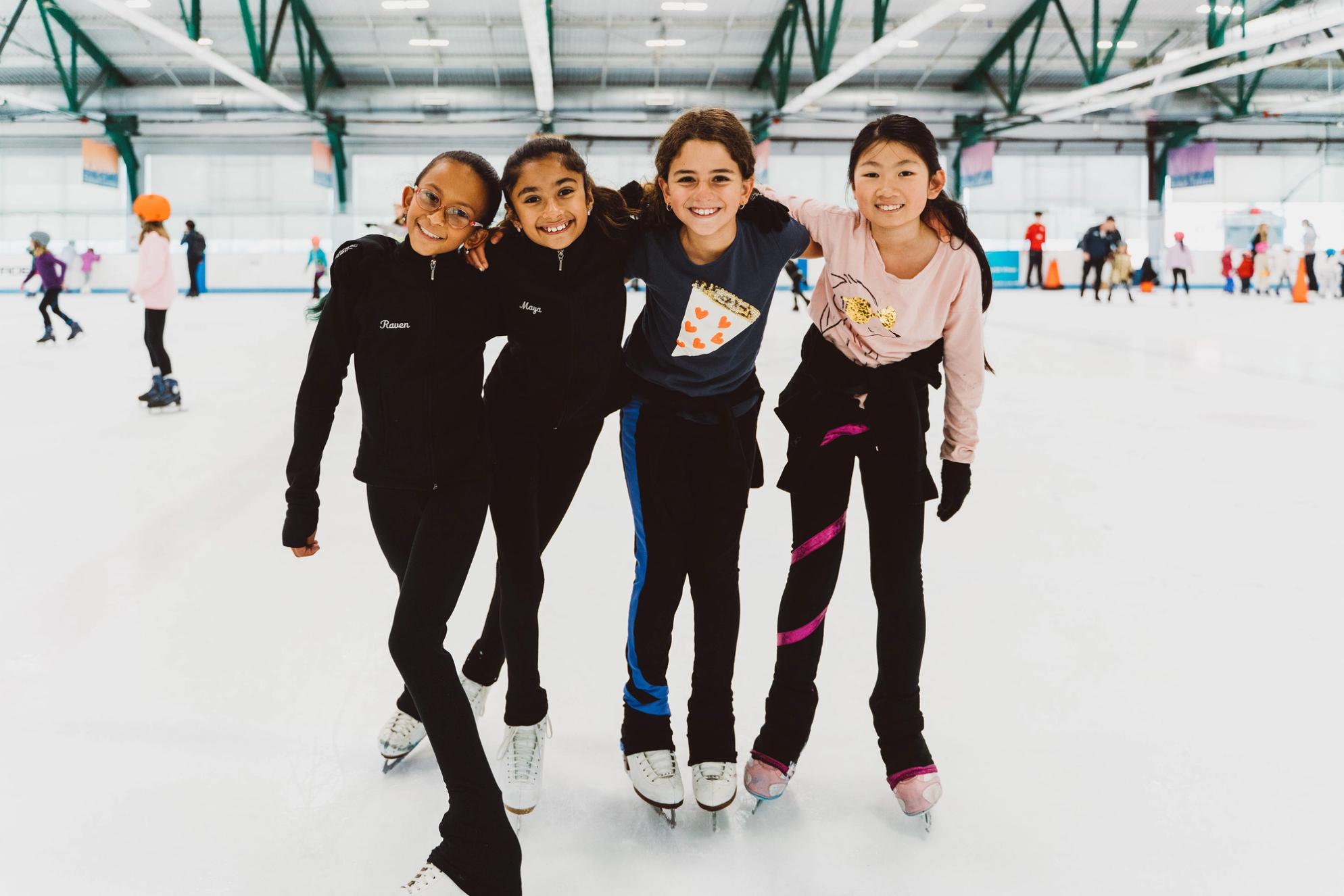 Group of girls smiling on the ice 