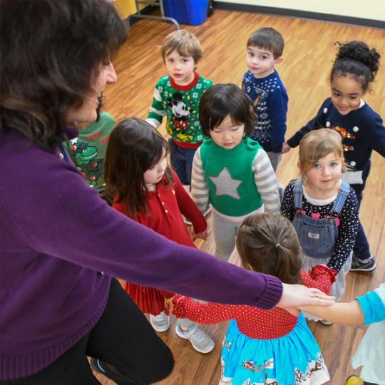 Music teacher playing music for kids