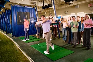 Golfing with friends at a driving range
