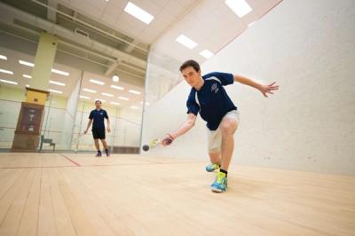 Adults playing squash