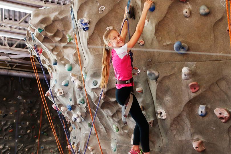 Girl bouldering at Chelsea Piers