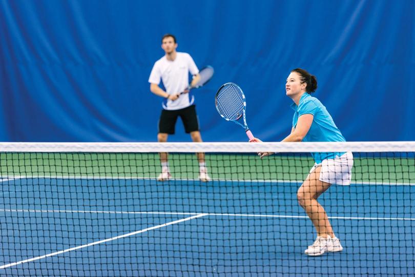 Adults playing tennis