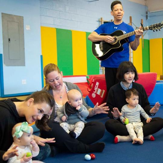 Music teacher playing music for kids