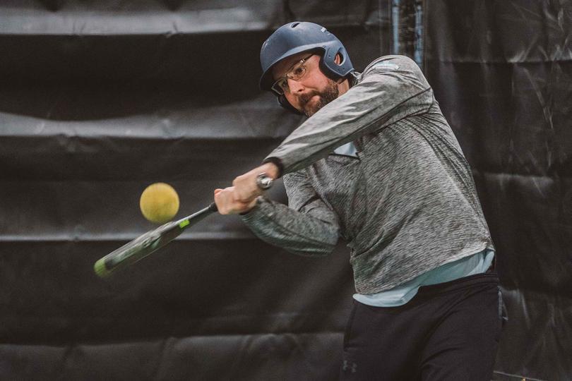 Person hitting in a batting cage