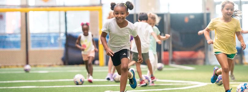 Kids running on a basketball court