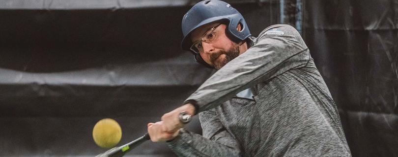 Man hitting a softball
