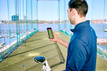 Golfer checking stats on phone