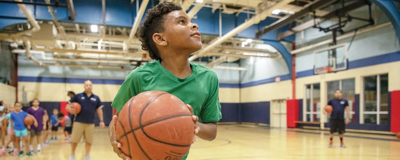 Kid getting ready to shoot a basketball
