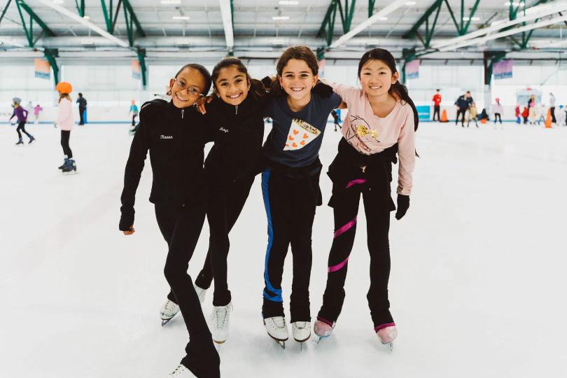 Four girls skating on ice