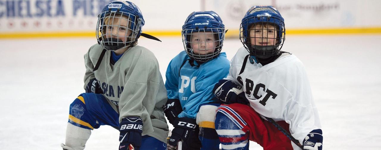 Cover photo of kids in hockey gear on ice