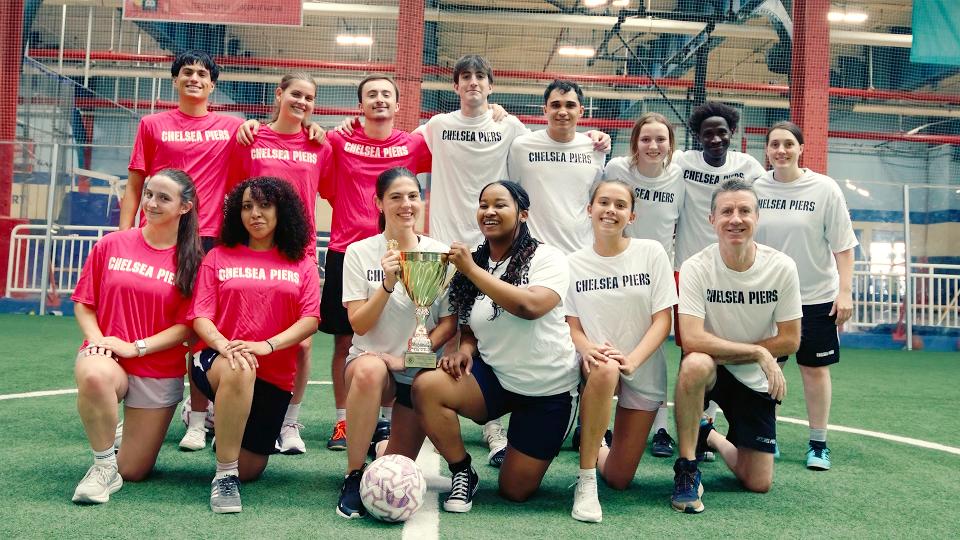 Soccer players posing holding trophy