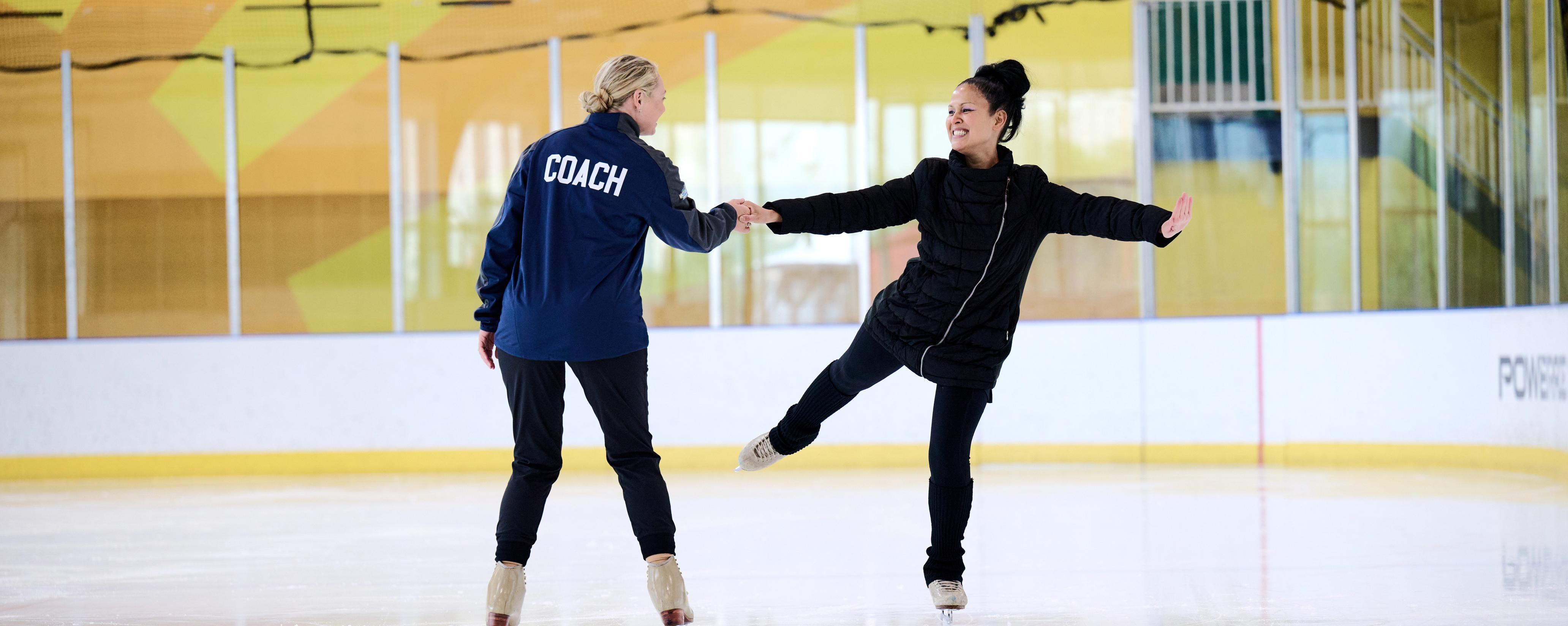 Ice skater skating with coach