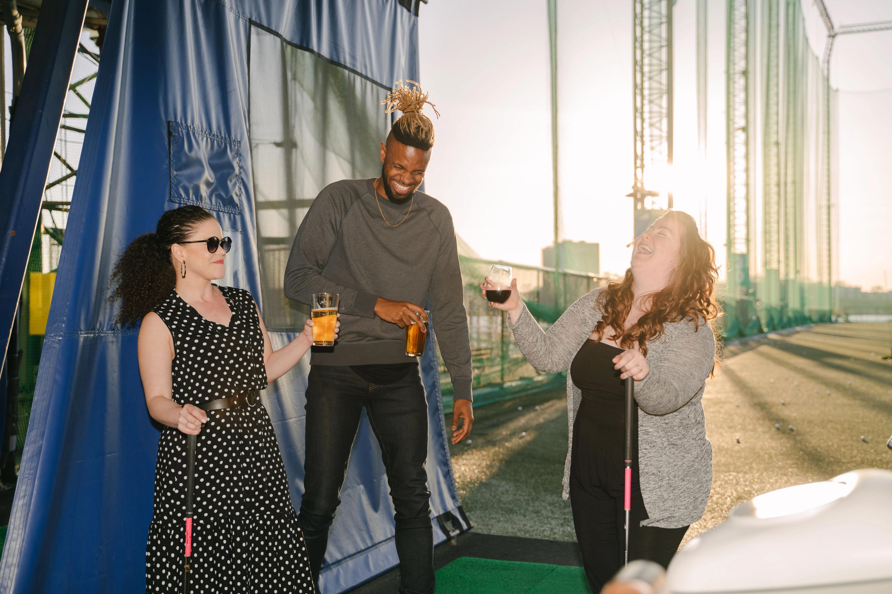 Friends having fun at the driving range