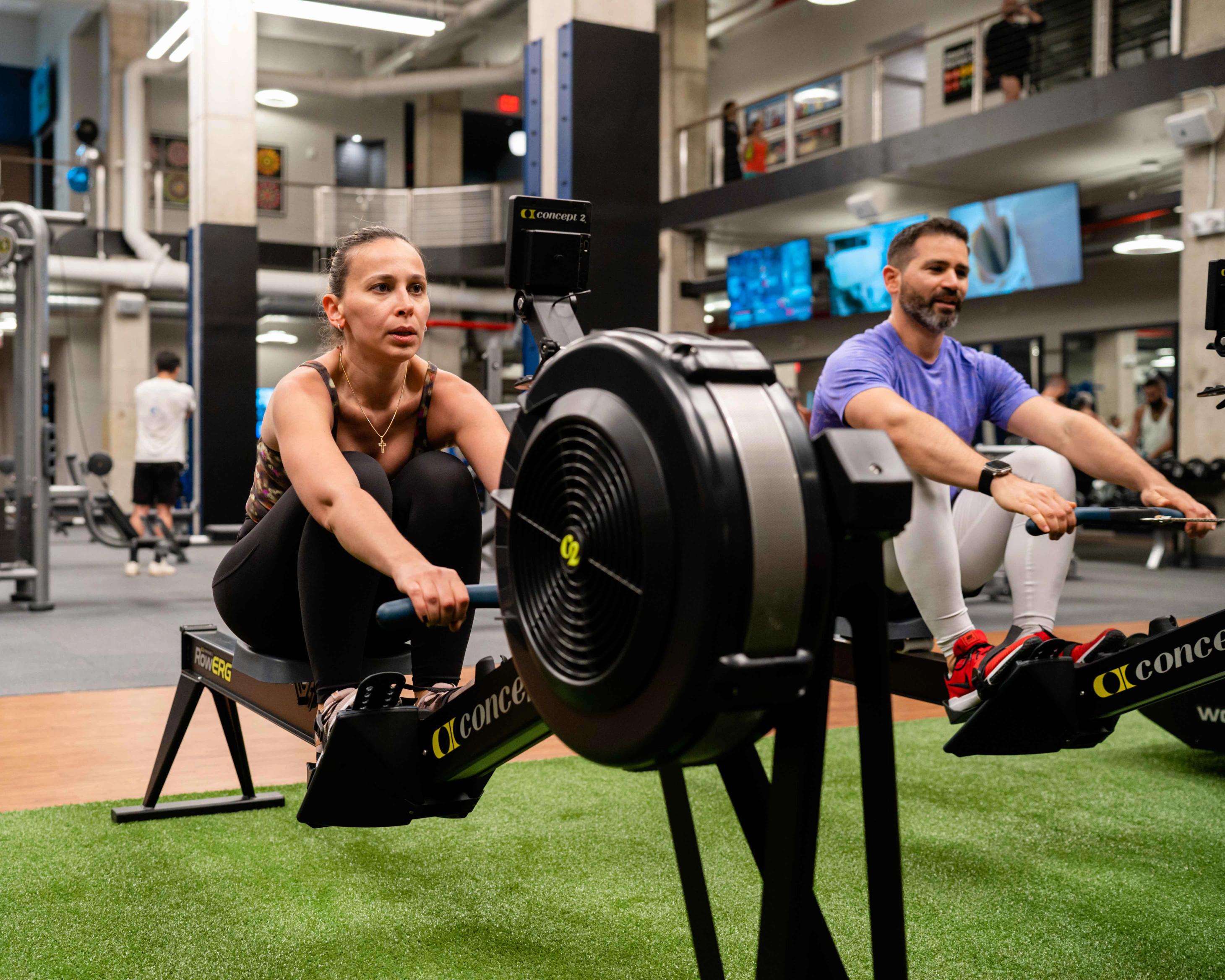 Guy and girl exercising at the gym